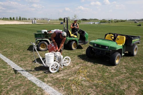 LOCAL -SOCCER FIELDS - Buhler Recreation Park. Workers on the field. The grass is pretty worn down centre field. They said that they are going to reseed it at the end of the month to keep it up. BORIS MINKEVICH/WINNIPEG FREE PRESS June 10, 2015