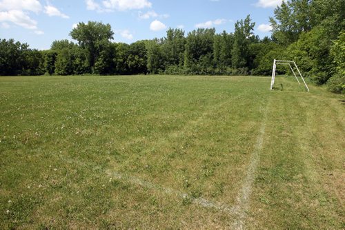 LOCAL -SOCCER FIELDS - Homestead Field in St. Boniface. Workers on the field. Grass needs to be cut. Grass worn away near the goal area. BORIS MINKEVICH/WINNIPEG FREE PRESS June 10, 2015