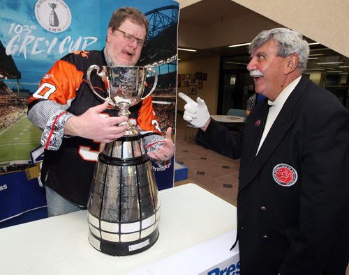 LOCAL -Doug Spiers horses around with Grey Cup handler Dan Maloney in the foyer of the Winnipeg Free Press. Doug column. BORIS MINKEVICH/WINNIPEG FREE PRESS June 10, 2015