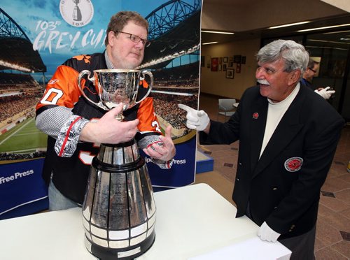 LOCAL -Doug Spiers horses around with Grey Cup handler Dan Maloney in the foyer of the Winnipeg Free Press. Doug column. BORIS MINKEVICH/WINNIPEG FREE PRESS June 10, 2015