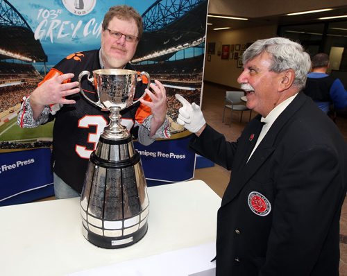 LOCAL -Doug Spiers horses around with Grey Cup handler Dan Maloney in the foyer of the Winnipeg Free Press. Doug column. BORIS MINKEVICH/WINNIPEG FREE PRESS June 10, 2015