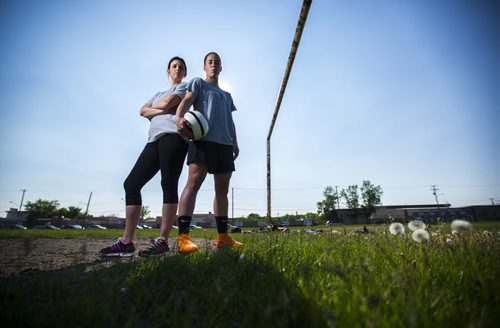 Soccer's Best manager Dana Kuhl (left) and Goalkeeper Chandra Bednar stand on a soccer field in the West End of Winnipeg on Wednesday, June 10, 2015.  Bednar has been playing for 15 years, and is hoping to go pro in Europe soon, but practicing on the hard dirt scrapes her elbows every time she dives to save the ball. Mikaela MacKenzie / Winnipeg Free Press