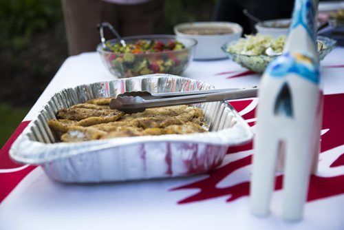 Food sits on the picnic table before guests dive in at a fish fry for soccer fans at Sonja Lundstrom's house on Wednesday, June 10, 2015.  Fried pickerel, maple beans, coleslaw, and homemade bread all made for a typically Canadian meal to serve to the Swedish fans. Mikaela MacKenzie / Winnipeg Free Press