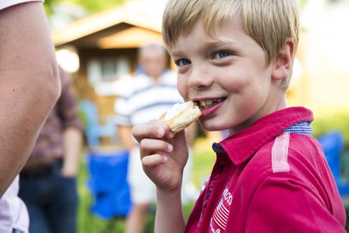 Isak Rosén eats some freshly-made bread at a fish fry for soccer fans at Sonja Lundstrom's house on Wednesday, June 10, 2015.  Rosén came over from Sweden with his family to watch the games. Mikaela MacKenzie / Winnipeg Free Press