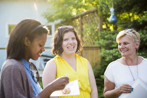 Hillary Coleman laughs with newly-made friends at a fish fry for soccer fans at Sonja Lundstrom's house on Wednesday, June 10, 2015.  Coleman drove to Winnipeg from Seattle, and is couch surfing at Sonja Lundstrom's house for the duration of FIFA. Mikaela MacKenzie / Winnipeg Free Press