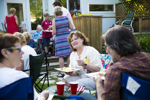 Ellen Boryen eats while chatting with friends at a fish fry for soccer fans at Sonja Lundstrom's house on Wednesday, June 10, 2015.  Fried pickerel, maple beans, coleslaw, and homemade bread all made for a typically Canadian meal to serve to the Swedish fans. Mikaela MacKenzie / Winnipeg Free Press