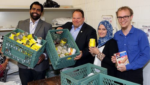 LOCAL - Left to Right. Former Winnipeg Bomber Ibrahim "Obby" Khan, Winnipeg Football Club CEO Wade Miller, Kobra Rahimi, and Joel Trono-Doerksen (corr spelling). They pose in a line where food kits are being made. Give 30 and Winnipeg Blue Bombers continued support of Winnipeg Harvest kick off soon. Give 30 is designed to motivate people to donate a portion of their money that would have been spent on lunch during Ramadan, a month of fasting in the Muslim faith. BORIS MINKEVICH/WINNIPEG FREE PRESS June 11, 2015