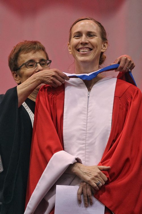Miriam Toews, receives the trappings of an Honorary Doctor of Letters from the UofW's President Annette Trimbee during the University of Winnipeg's 105th Spring Convocation  at Duckworth Centre Thursday morning.  150611 June 11, 2015 MIKE DEAL / WINNIPEG FREE PRESS