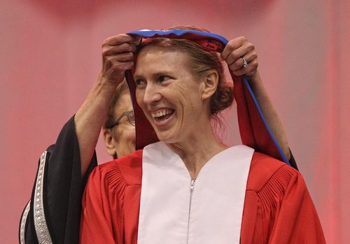 Miriam Toews, receives the trappings of an Honorary Doctor of Letters from the UofW's President Annette Trimbee during the University of Winnipeg's 105th Spring Convocation  at Duckworth Centre Thursday morning.  150611 June 11, 2015 MIKE DEAL / WINNIPEG FREE PRESS