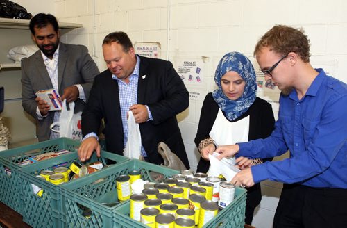 LOCAL - Left to Right. Former Winnipeg Bomber Ibrahim "Obby" Khan, Winnipeg Football Club CEO Wade Miller, Kobra Rahimi, and Joel Trono-Doerksen (corr spelling). They pose in a line where food kits are being made. Give 30 and Winnipeg Blue Bombers continued support of Winnipeg Harvest kick off soon. Give 30 is designed to motivate people to donate a portion of their money that would have been spent on lunch during Ramadan, a month of fasting in the Muslim faith. BORIS MINKEVICH/WINNIPEG FREE PRESS June 11, 2015