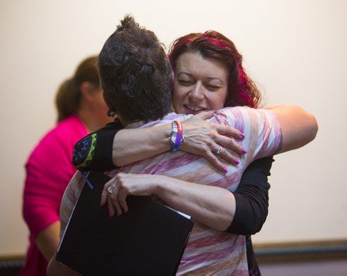 Sharon Blady hugs Owen Campbell after he gave a personal talk about support for transgendered people at the Klinic Community Health Centre in Winnipeg on Friday, June 12, 2015.  Mikaela MacKenzie / Winnipeg Free Press