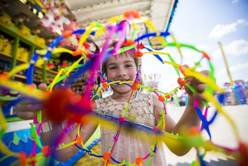 Sara Mansky, six, is very happy to receive her prize at the Red River Exhibition on opening day in Winnipeg on Friday, June 12, 2015.  Mikaela MacKenzie / Winnipeg Free Press