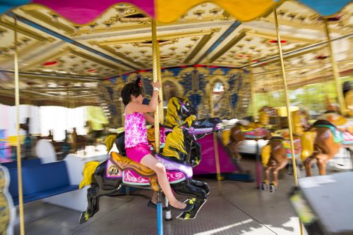 Zoey Traverse, seven, rides the carousel at the Red River Exhibition on opening day in Winnipeg on Friday, June 12, 2015.  Traverse goes to the exhibition every year. Mikaela MacKenzie / Winnipeg Free Press