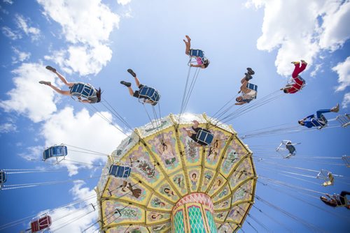 People fly up in the air on a ride at the Red River Exhibition on opening day in Winnipeg on Friday, June 12, 2015.  Mikaela MacKenzie / Winnipeg Free Press