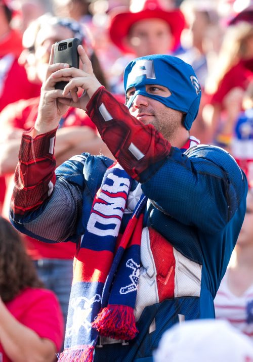 A fan dressed as Captain America snaps a photo as the U.S. Women's National Team enters the stadium for their match against Sweden at the FIFA Women's World Cup in Winnipeg.  June 12, 2015 - MELISSA TAIT / WINNIPEG FREE PRESS