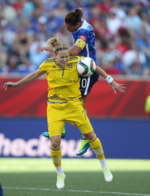 Team USA Carli Lloyd , front, ties it up with Team Swedens Lisa Dahlkvist during first half action at the FIFA Womens World Cup at Investors Group Field Friday night .  See story- June 12, 2015   (JOE BRYKSA / WINNIPEG FREE PRESS)