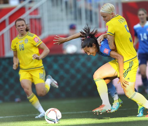 Team USA Christen Press is hauled down by Team Swedens Nilla Fisher on a breakaway during first half action at the FIFA Womens World Cup at Investors Group Field Friday night .  See story- June 12, 2015   (JOE BRYKSA / WINNIPEG FREE PRESS)