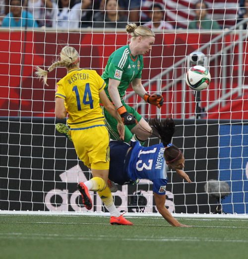 Team Sweden  goaltender Hedviq Lindahl and her teammate Amanda Ilestedt  made a great save on Team USA Alex Morgan during second half action at the FIFA Womens World Cup at Investors Group Field Friday night .  See story- June 12, 2015   (JOE BRYKSA / WINNIPEG FREE PRESS)