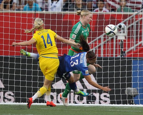 Team Sweden  goaltender Hedviq Lindahl and her teammate Amanda Ilestedt  made a great save on Team USA Alex Morgan during second half action at the FIFA Womens World Cup at Investors Group Field Friday night .  See story- June 12, 2015   (JOE BRYKSA / WINNIPEG FREE PRESS)