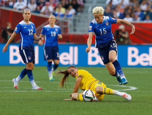 U.S. midfielder Megan Rapinoe hurdles over Sweden midfielder Emilia appelqcvist in the second half of a 0-0 tie. FIFA Women's World Cup Friday evening at Investors Group Field June 12, 2015 - MELISSA TAIT / WINNIPEG FREE PRESS