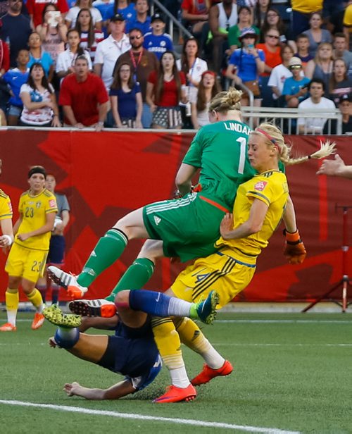 Swedish goalkeeper Hedvig Lindahl (FIFA Player of the Game) makes a save and collides with Swedish defender Amanda Ilestedt and U.S. forward Alex Morgan in the second half of the 0-0 tie. FIFA Women's World Cup Nigeria USA vs Sweden on Friday evening at Investors Group Field June 12, 2015 - MELISSA TAIT / WINNIPEG FREE PRESS