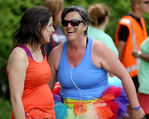 Kelly Seneshen and Liz Hanes, participants in the inaugural 5km Pride Run, making their way along Waterfront Drive, Saturday, June 13, 2015. (TREVOR HAGAN/WINNIPEG FREE PRESS)