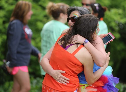 Kelly Seneshen and Liz Hanes, participants in the inaugural 5km Pride Run, making their way along Waterfront Drive, Saturday, June 13, 2015. (TREVOR HAGAN/WINNIPEG FREE PRESS)