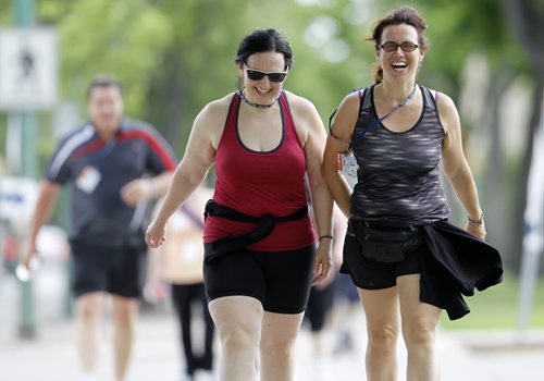 Mary Bertone and Lorianne Lytle, participants heading along Broadway during the 20km Challenge for Life CancerCare Walk, Saturday, June 13, 2015. (TREVOR HAGAN/WINNIPEG FREE PRESS)