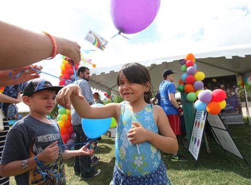 Six-year-old Kalissa  Redstar has her purple balloon tied to her wrist to keep it from blowing away while attending Pride Fest at the Forks with her family Saturday.  Standup photo   June 13, 2015 Ruth Bonneville / Winnipeg Free Press