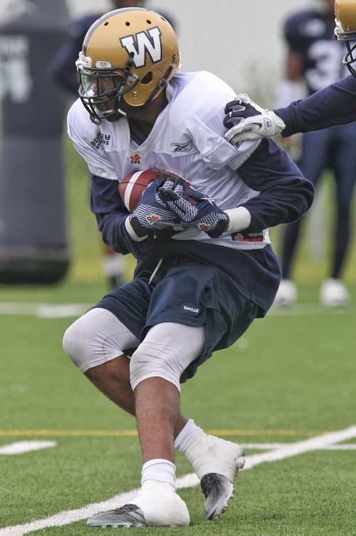 Darvin Adams (4) catches the ball during Winnipeg Blue Bomber practice at the soccer pitch beside Investors Group Field Sunday morning.  150614 June 14, 2015 MIKE DEAL / WINNIPEG FREE PRESS