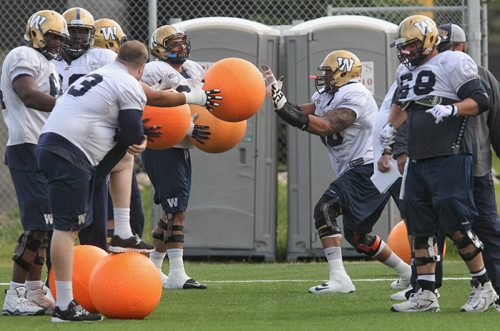 The offensive line works out with the big balls during Winnipeg Blue Bombers practice Monday morning.  150615 June 15, 2015 MIKE DEAL / WINNIPEG FREE PRESS