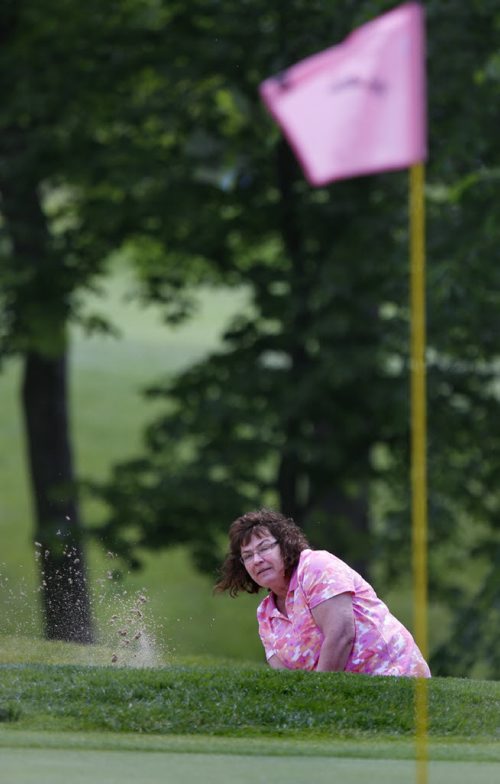 Kathy Popovic chips some sand towards the pin during the Pink Ribbon Ladies Golf Classic for Hope at the Niakwa Country Club Monday.   About 160 women golfed in the annual fundraising event for CancerCare Manitobas Breast Cancer Centre of Hope. Wayne Glowacki / Winnipeg Free Press June 15 2015