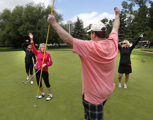 Scorekeeper Doug Speirs celebrates shot with golfers from left,  Jill Baczynsky, Joan Walton and Karen Russell during the Pink Ribbon Ladies Golf Classic for Hope at the Niakwa Country Club Monday.   About 160 women golfed in the annual fundraising event for CancerCare Manitobas Breast Cancer Centre of Hope. Wayne Glowacki / Winnipeg Free Press June 15 2015