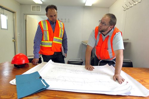 (L-R) Larry Halayko, Director for contract services-Manitoba Infrastructure and Transportation and Steve Penner, Sr. Project Manager-Manitoba Infrastructure and Transportation.  Dan Lett feature on hwy 75 construction - comparing canada/US.  In site office in Ste. Agathe, MB looking at the plans.  BORIS MINKEVICH/WINNIPEG FREE PRESS June 25, 2014