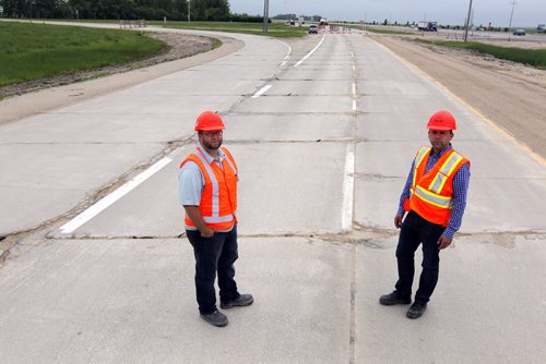 (L-R) Steve Penner, Sr. Project Manager-Manitoba Infrastructure and Transportation and  Larry Halayko, Director for contract services-Manitoba Infrastructure and Transportation. Dan Lett feature on hwy 75 construction - comparing canada/US. Here they stand on some real rough road they are gonna replace near Ste. Agathe, MB.   BORIS MINKEVICH/WINNIPEG FREE PRESS June 25, 2014