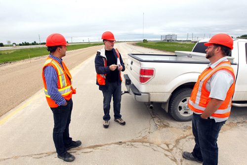 (L-R) Larry Halayko, Director for contract services-Manitoba Infrastructure and Transportation, reporter Dan Lett,  and Steve Penner, Sr. Project Manager-Manitoba Infrastructure and Transportation.  Dan Lett feature on hwy 75 construction - comparing canada/US.  Here they stand on some real rough road they are gonna replace near Ste. Agathe, MB.  BORIS MINKEVICH/WINNIPEG FREE PRESS June 25, 2014