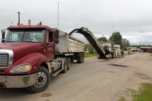 Ste. Agathe, MB.  Crews grind out the road there for reconstruction. Dan Lett feature on hwy 75 construction - comparing canada/US.  BORIS MINKEVICH/WINNIPEG FREE PRESS June 25, 2014