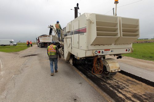 Ste. Agathe, MB.  Crews grind out the road there for reconstruction. Dan Lett feature on hwy 75 construction - comparing canada/US.  BORIS MINKEVICH/WINNIPEG FREE PRESS June 25, 2014