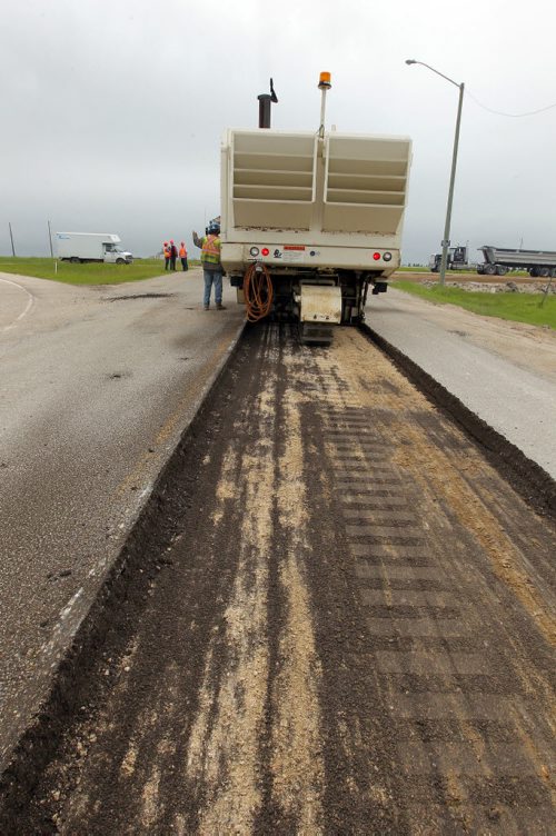 Ste. Agathe, MB.  Crews grind out the road there for reconstruction. Dan Lett feature on hwy 75 construction - comparing canada/US.  BORIS MINKEVICH/WINNIPEG FREE PRESS June 25, 2014