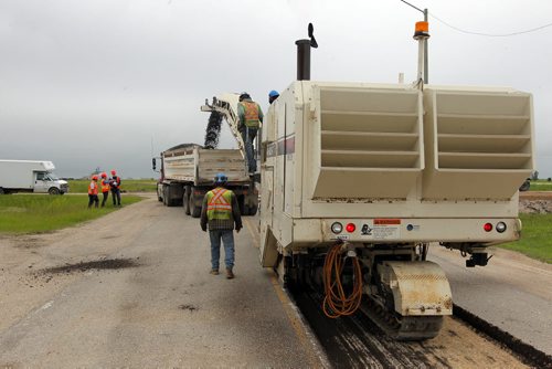 Ste. Agathe, MB.  Crews grind out the road there for reconstruction. Dan Lett feature on hwy 75 construction - comparing canada/US.  BORIS MINKEVICH/WINNIPEG FREE PRESS June 25, 2014