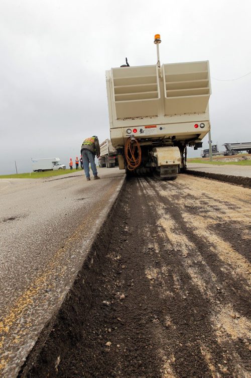 Ste. Agathe, MB.  Crews grind out the road there for reconstruction. Dan Lett feature on hwy 75 construction - comparing canada/US.  BORIS MINKEVICH/WINNIPEG FREE PRESS June 25, 2014