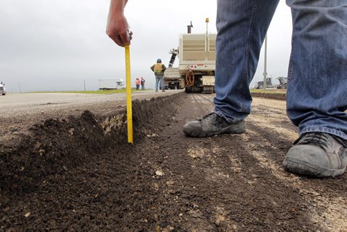 Ste. Agathe, MB.  Crews grind out the road there for reconstruction. Dan Lett feature on hwy 75 construction - comparing canada/US.  Here they measure how deep they went.  BORIS MINKEVICH/WINNIPEG FREE PRESS June 25, 2014