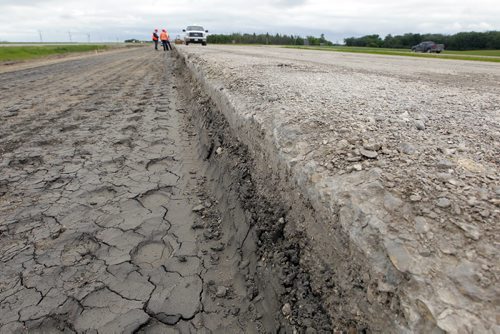 Ste. Agathe, MB.  After the shoulder is packed down a special cloth is put down to help stop damage. Dan Lett feature on hwy 75 construction - comparing canada/US.  Here on the left is the shoulder and on the right is the crumbling highway. BORIS MINKEVICH/WINNIPEG FREE PRESS June 25, 2014