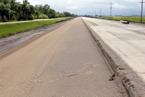Ste. Agathe, MB.  After the shoulder is packed down a special cloth is put down to help stop damage. Dan Lett feature on hwy 75 construction - comparing canada/US.   The shoulder ready and packed with special cloth under. BORIS MINKEVICH/WINNIPEG FREE PRESS June 25, 2014
