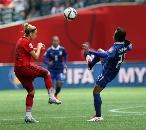 Germany's #15 Jennifer Cramer and Thailand's #21 aim for the ball in Monday's FIFA Match at Investors Field in Winnipeg. See story. June 15, 2015 - (Phil Hossack / Winnipeg Free Press)