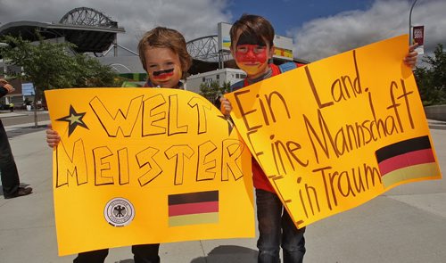 German fans Roan Matyas (left), 7, and Luca Matyas, 9, get into the spirit as they approach the entrance to the stadium for the FIFA Women's World Cup match between Germany and Thailand Monday afternoon in Winnipeg.  150615 June 15, 2015 MIKE DEAL / WINNIPEG FREE PRESS