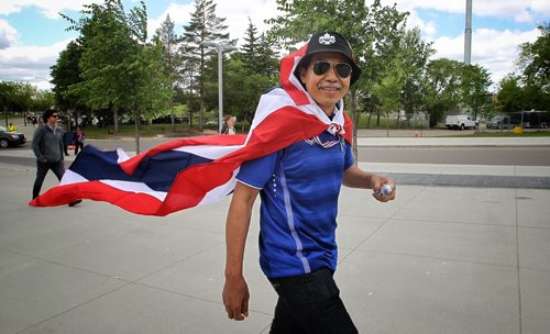 Thailand fan, Sawai Imthon who came for the games from Thailand gets into the spirit as he approaches the entrance to the stadium for the FIFA Women's World Cup match between Germany and Thailand Monday afternoon in Winnipeg.  150615 June 15, 2015 MIKE DEAL / WINNIPEG FREE PRESS