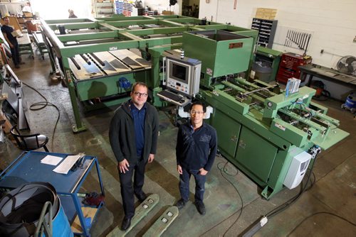 Micro Tool & Machine Ltd. makes sophisticated transformer manufacturing machines. They have exported to about 40 countries. Its getting ready to ship a big innovative new machine to China which could have an impact on the industry. (L-R) Gord Atamanchuk and Andrew Chan pose for a photo with the that machine. BORIS MINKEVICH/WINNIPEG FREE PRESS June 15, 2015