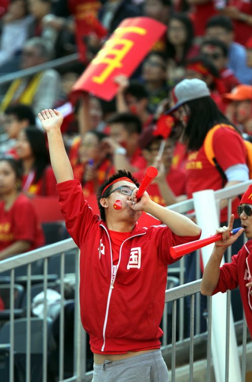 Chinese fans wave the flag during the warm up to China and New Zealand's match Monday at Investor's FIeld FIFA action. See story. June 15, 2015 - (Phil Hossack / Winnipeg Free Press)