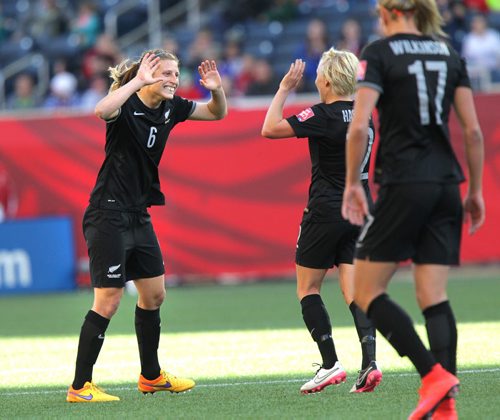 New Zealand's #6 Rebekah Stott grins while waiting for her team mate's congratulations after opening the scoring against team China in FIFA action at Investor's FIeld in WInnipeg Monday. June 15, 2015 - (Phil Hossack / Winnipeg Free Press)